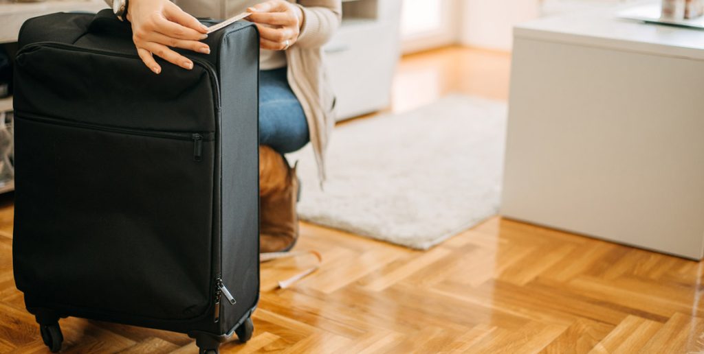 the woman is measuring her hand luggage