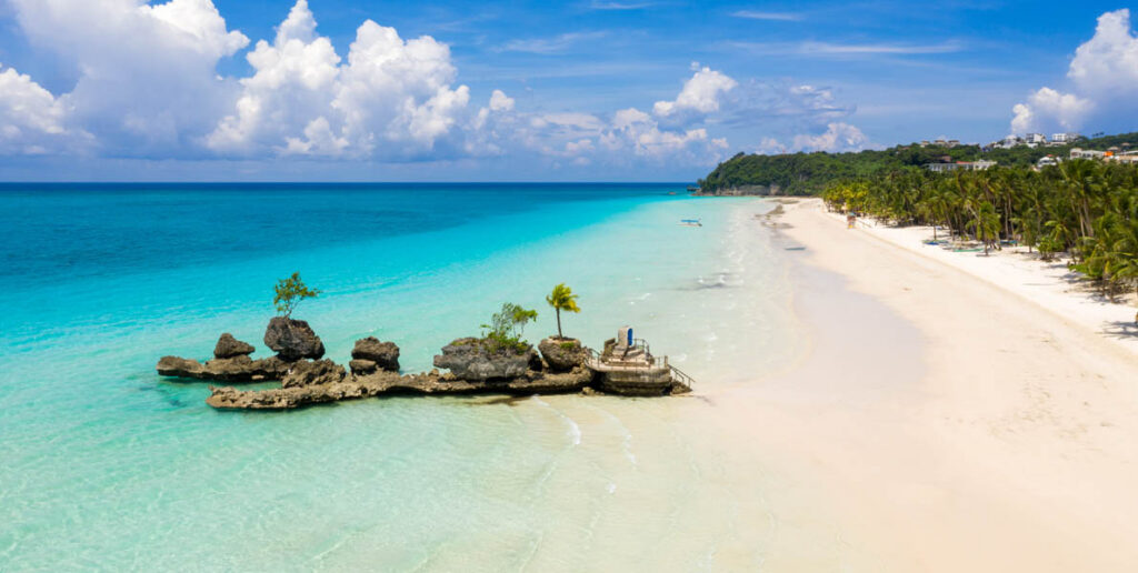 The image shows Willy's Rock on White Beach in Boracay, Philippines